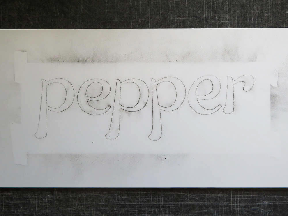 pounced pattern onto a sign panel