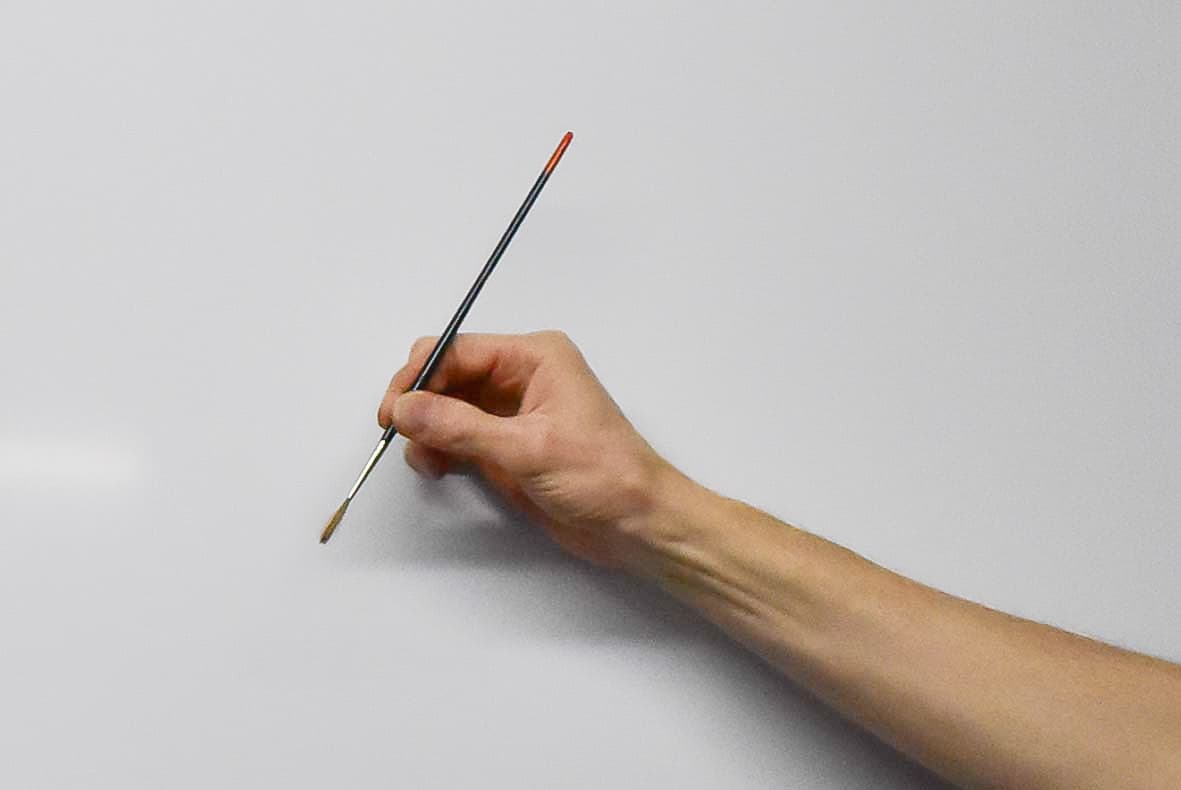 Holding a signwriting brush