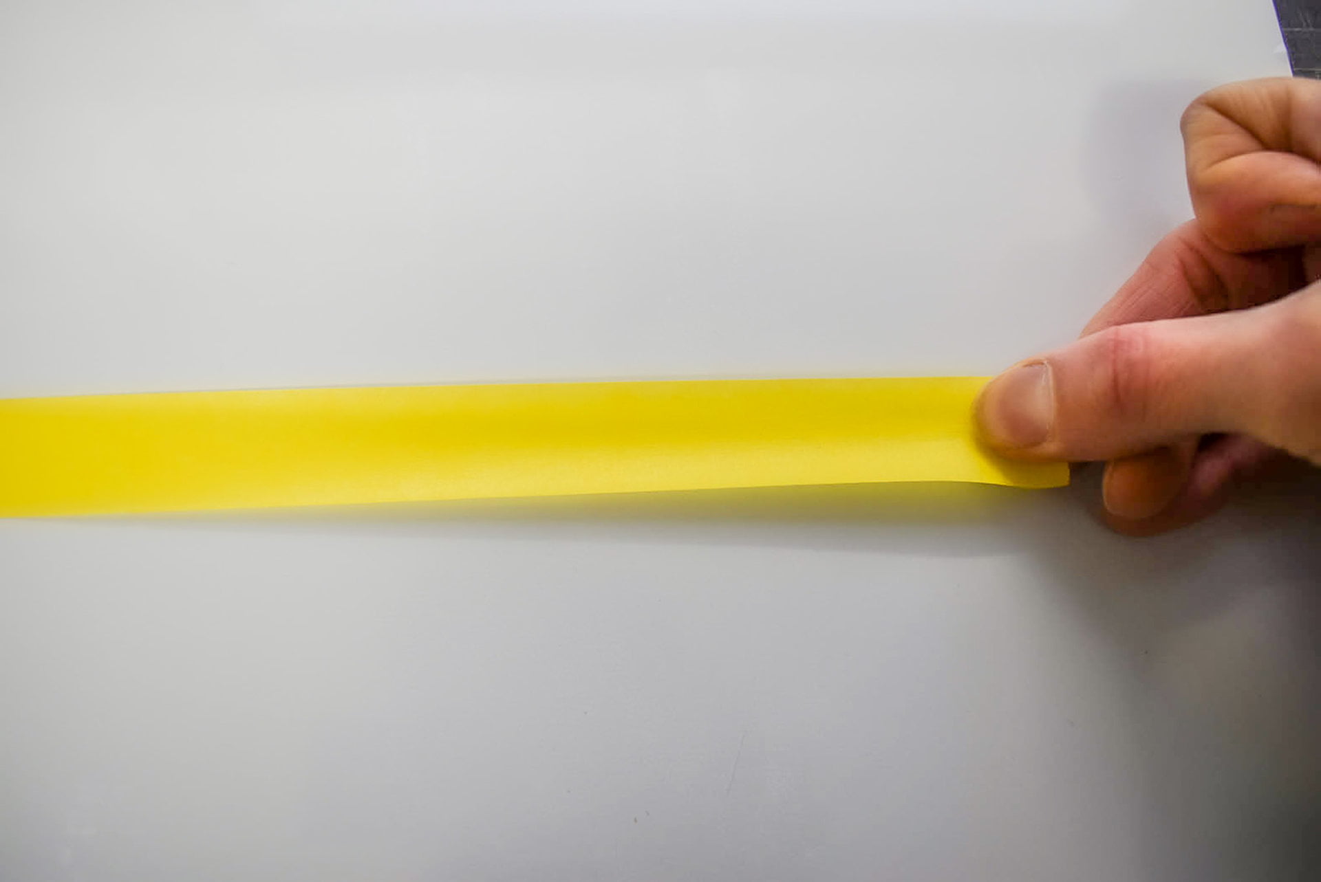 Pulling end of masking tape for making signs